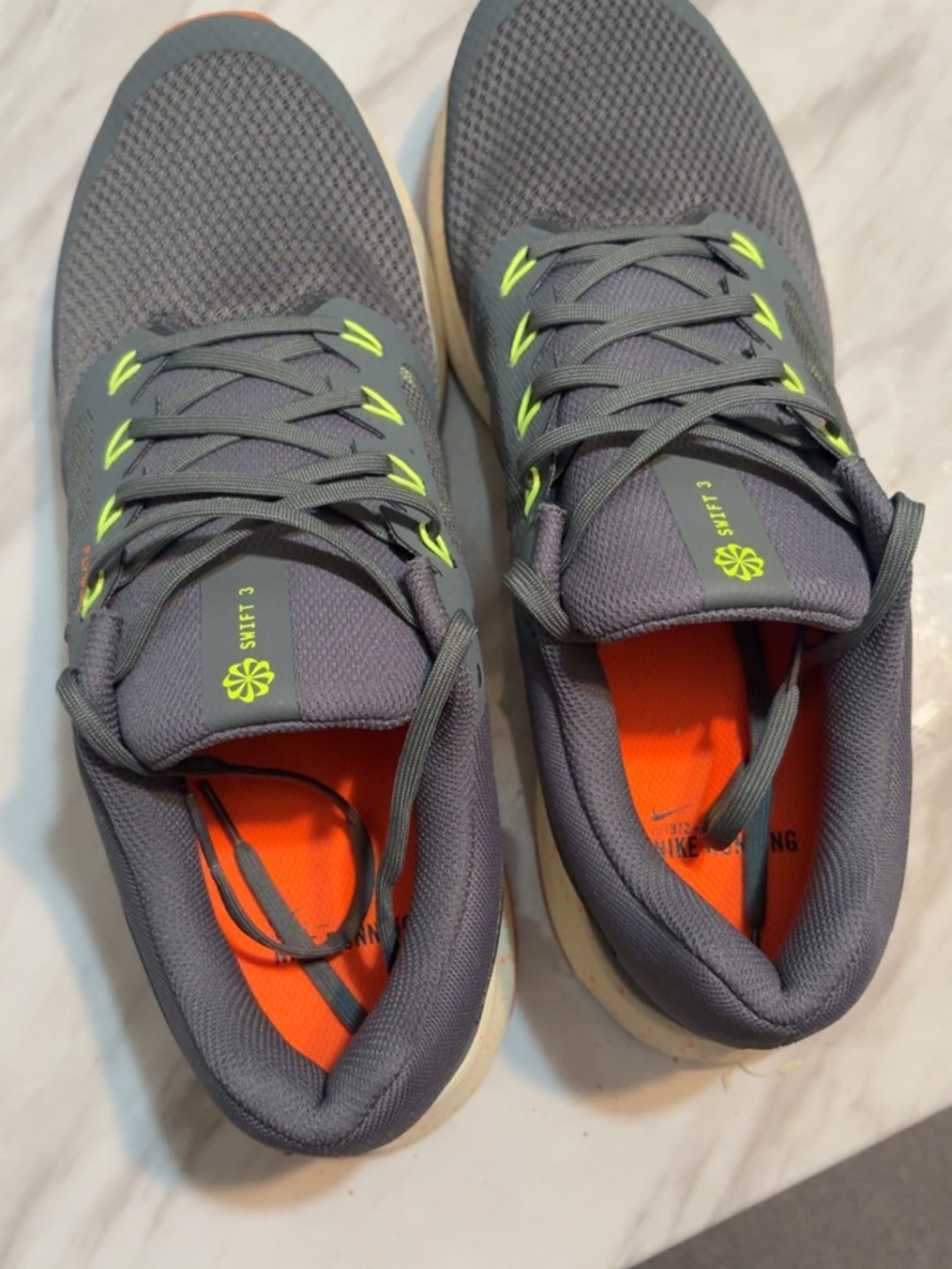 Nike Gray Athletic Running Shoes with Neon Yellow and Orange Accents